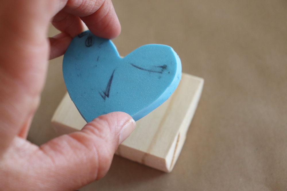 Rubber stamp being stamped on wood block
